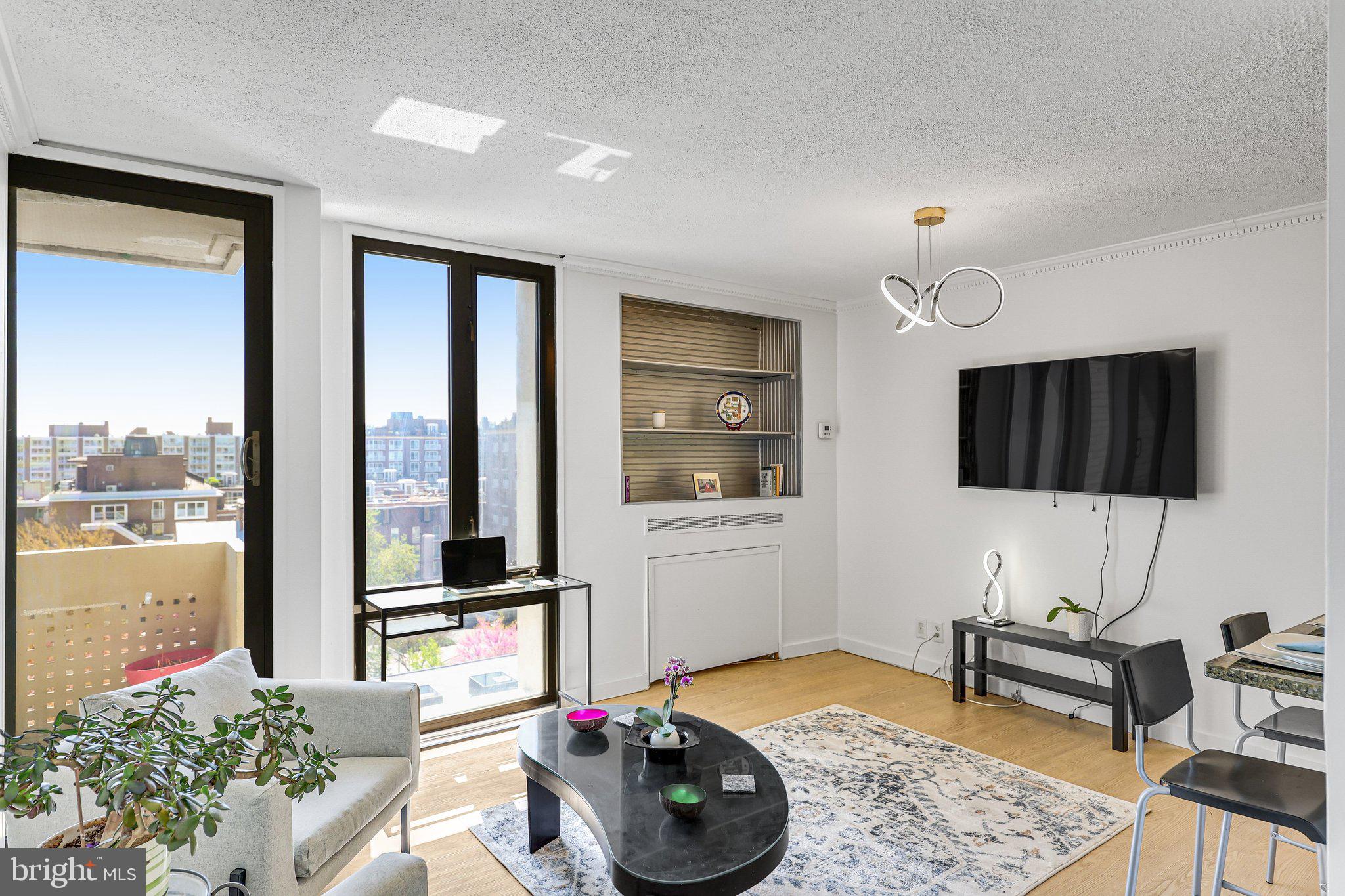 1245 4th Street Southwest, Unit E711 Washington, DC 20024 - Photo 3 of 33 a living room with furniture and a flat screen tv
