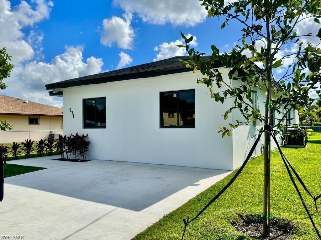 871 Southwest 2nd Street Homestead, FL 33034 - Photo 2 of 12 a backyard of a house with lots of green space