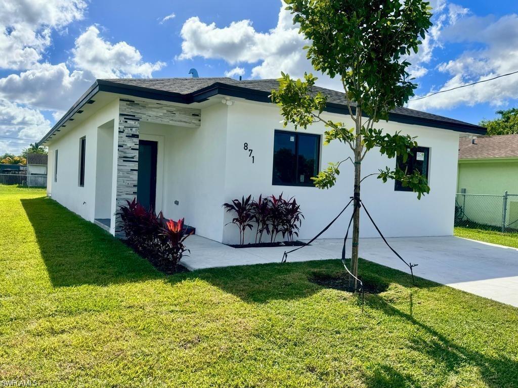 871 Southwest 2nd Street Homestead, FL 33034 - Photo 3 of 12 a front view of a house with garden
