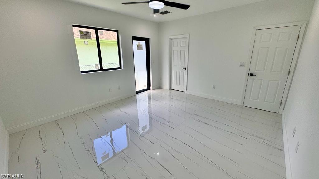 871 Southwest 2nd Street Homestead, FL 33034 - Photo 5 of 12 wooden floor in an empty room with a window