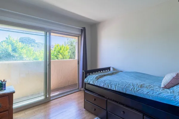 a bedroom with a large bed and a large window