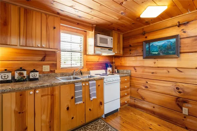 a view of a dining room with furniture a chandelier and wooden floor