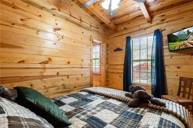 a bed sitting in a bedroom next to a window