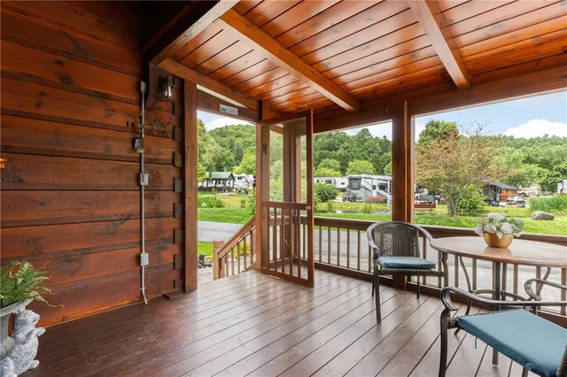 a view of a water pond with green yard