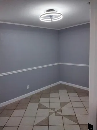 an empty room with white walls and tiles