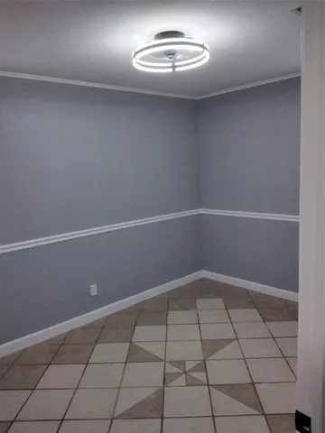 an empty room with white walls and tiles