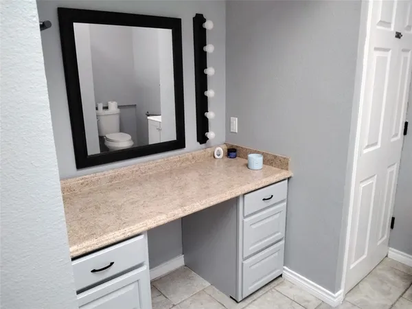 a bathroom with a sink a vanity and a mirror