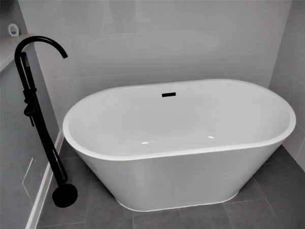 a white bath tub sitting in a bathroom