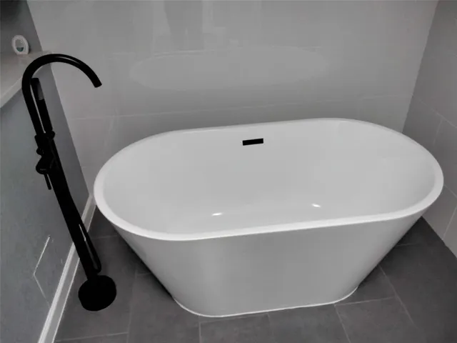 a white bath tub sitting in a bathroom