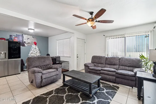 a living room with furniture and a ceiling fan