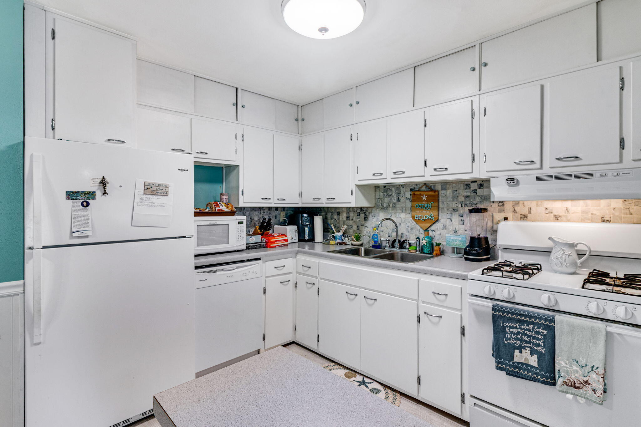 103 Adkinson Drive Crestview, FL 32536 - Photo 9 of 19 a kitchen with cabinets appliances a sink and a counter space