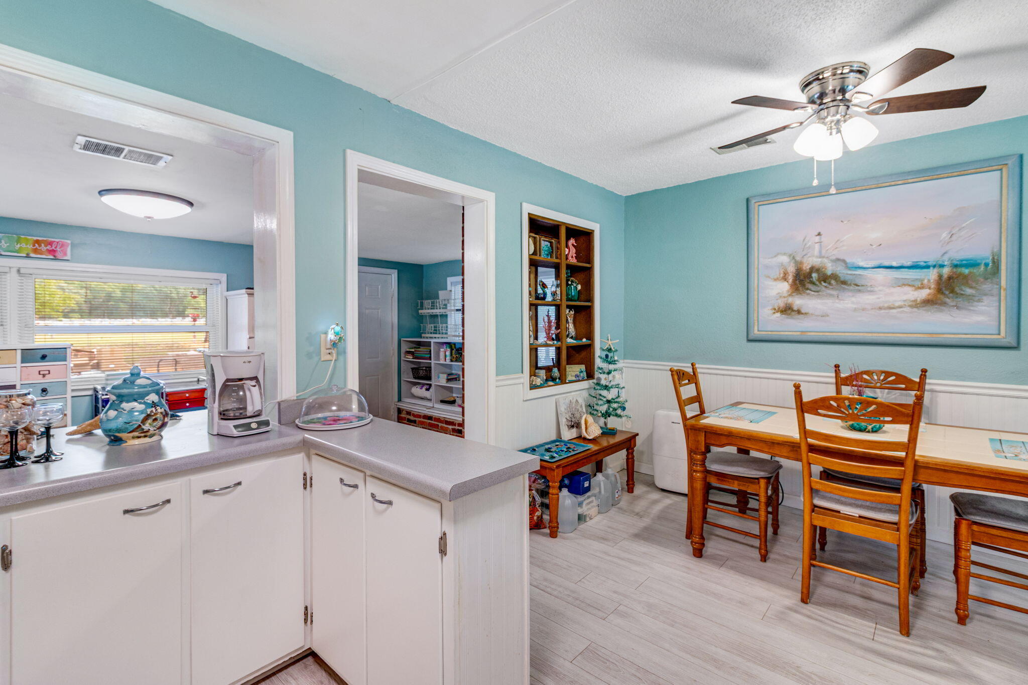 103 Adkinson Drive Crestview, FL 32536 - Photo 10 of 19 a view of a workspace with furniture and a kitchen