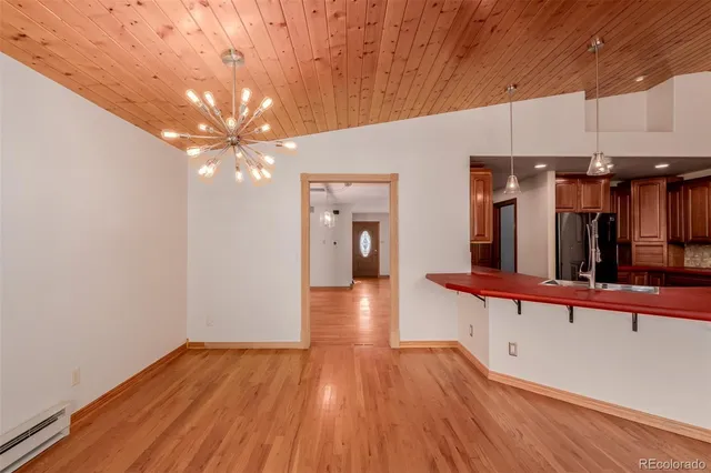 a view of a room with wooden floor