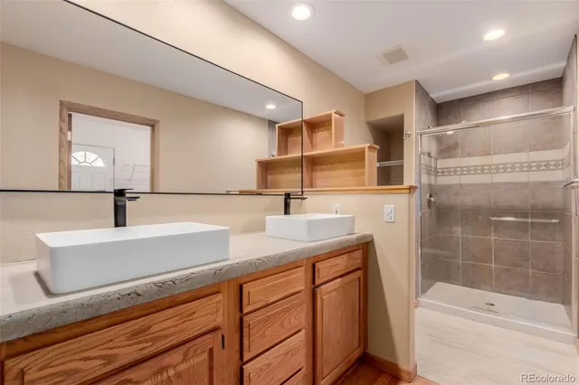 a bathroom with a sink a toilet and shower