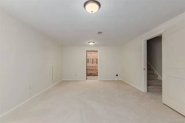 an empty room with closet and windows