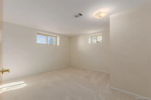 an empty room with a empty space and windows