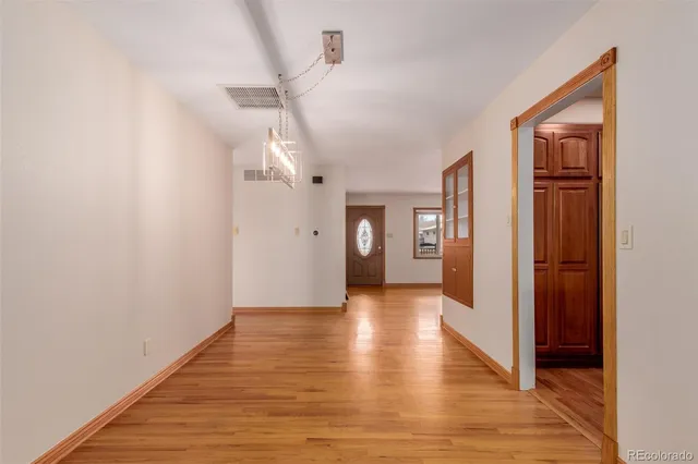 a view of a hallway with wooden floor