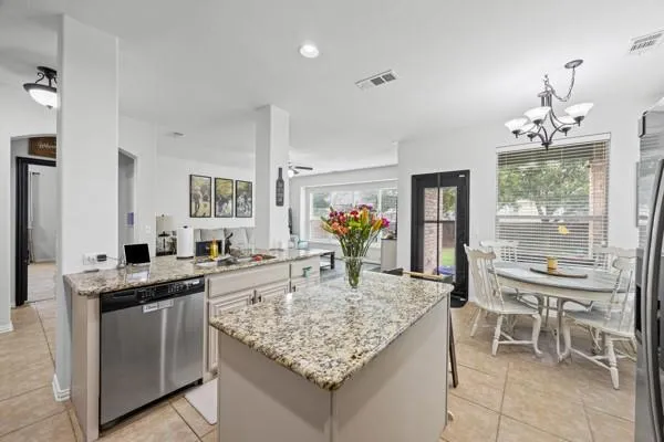 a kitchen with granite countertop kitchen island cabinets and stove