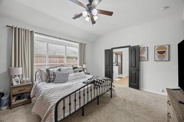 a bedroom with a bed and a chandelier