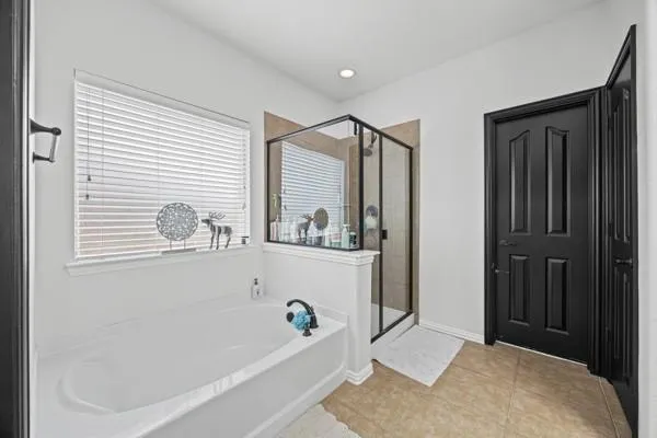 a bathroom with a bathtub and a shower