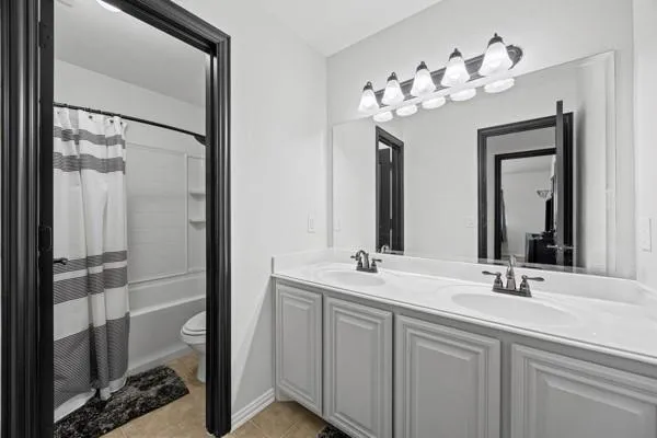 a bathroom with a double vanity sink and a mirror