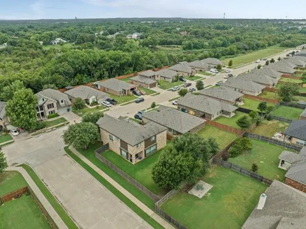 an aerial view of a house with a yard