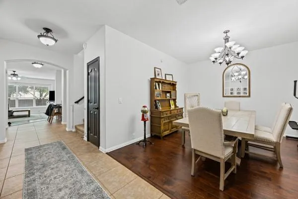a view of a dining room with furniture wooden floor and a chandelier