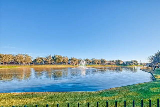 a view of a lake with houses in the back