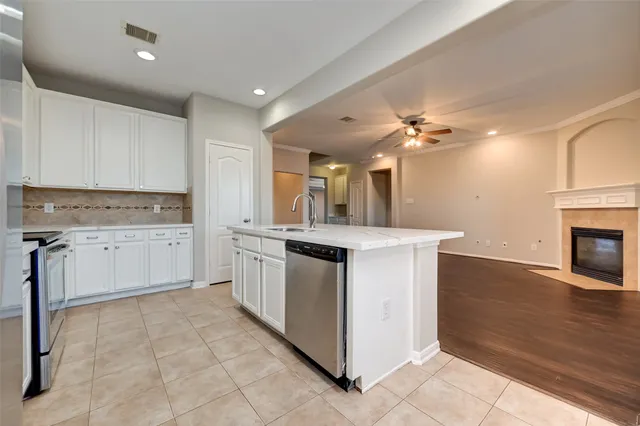 a kitchen with a stove sink and cabinets