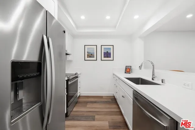 a kitchen with a sink and refrigerator