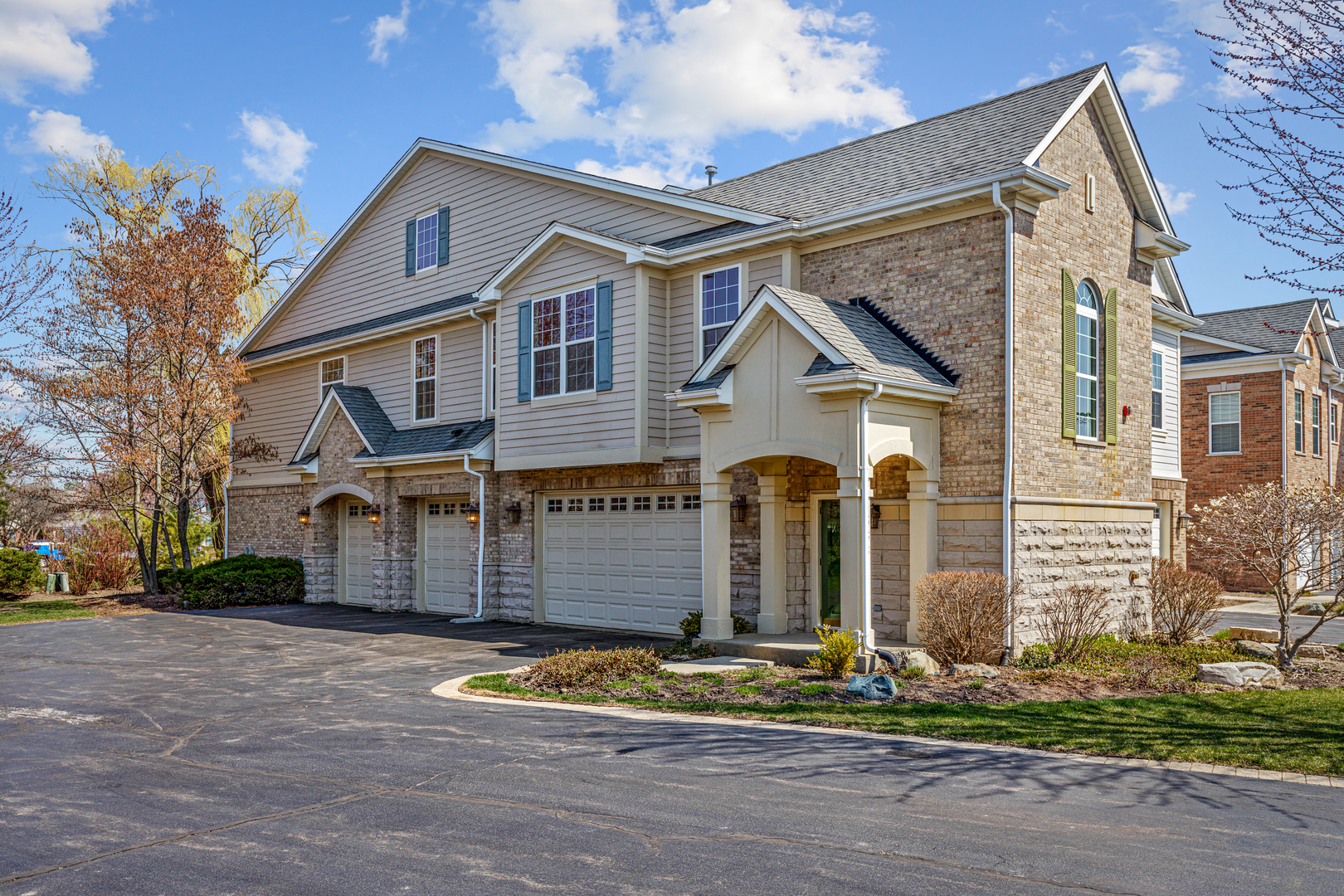 1388 Scarboro Road, Unit 1103 Schaumburg, IL 60193 - Photo 1 of 17 a front view of a house with a garden