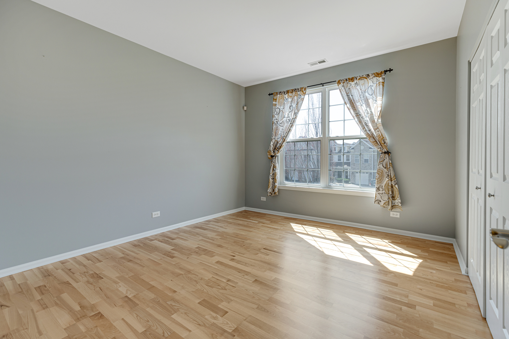 1388 Scarboro Road, Unit 1103 Schaumburg, IL 60193 - Photo 11 of 17 a view of an empty room with a window