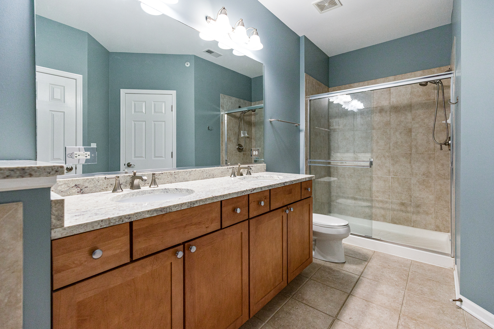 1388 Scarboro Road, Unit 1103 Schaumburg, IL 60193 - Photo 13 of 17 a bathroom with a sink double vanity and a shower