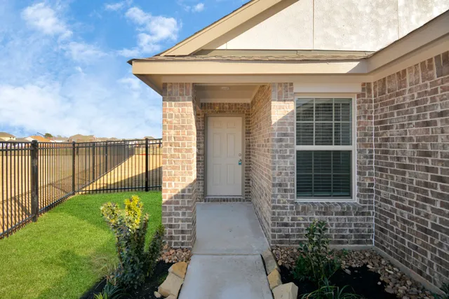 a view of a porch with a floor to ceiling window next to a yard