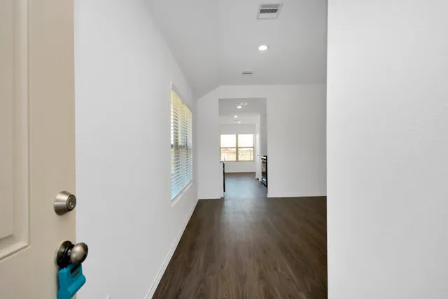a view of a hallway with wooden floor