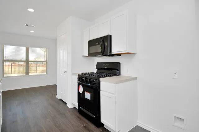 a kitchen with a stove and a microwave