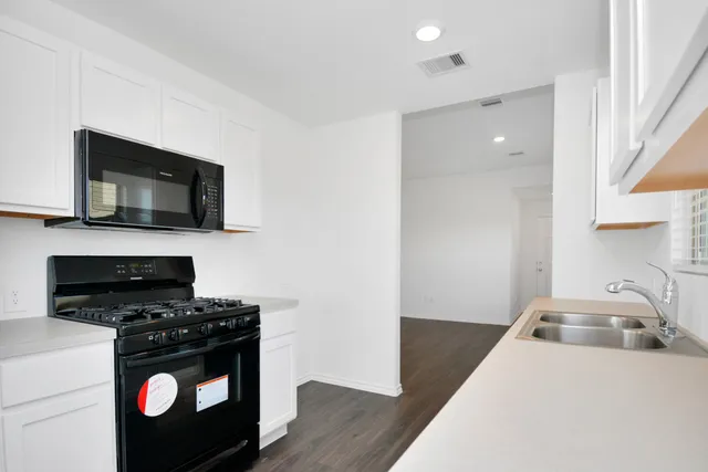 a kitchen with a stove and a microwave