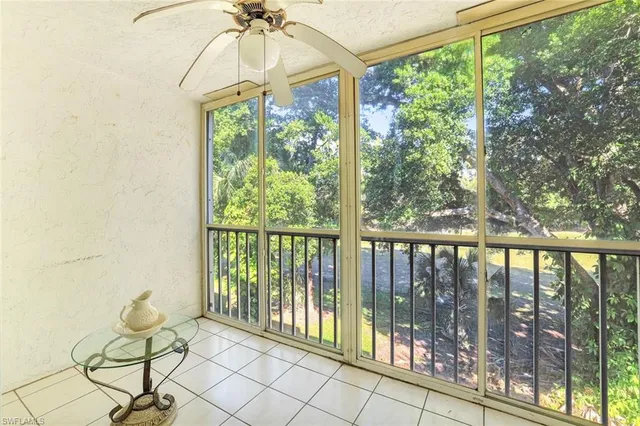 a view of a room with furniture and windows