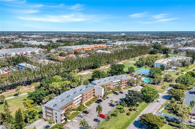 an aerial view of residential houses with outdoor space and trees all around