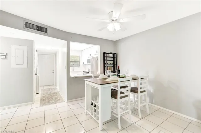 a view of a kitchen with a dining table and chairs