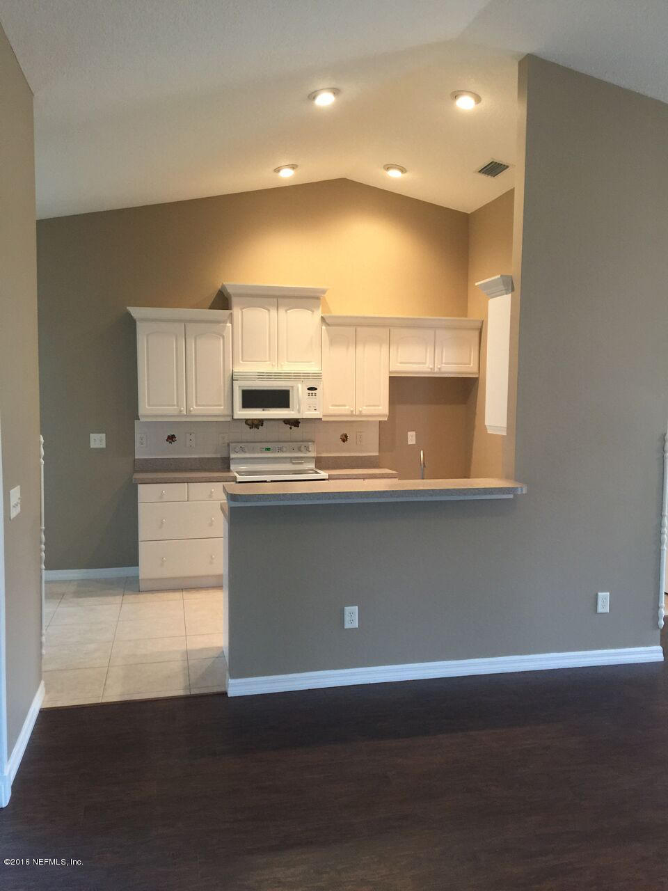 232 Orchis Road St. Augustine, FL 32086 - Photo 3 of 25 a view of a kitchen with a sink wooden cabinets and a window