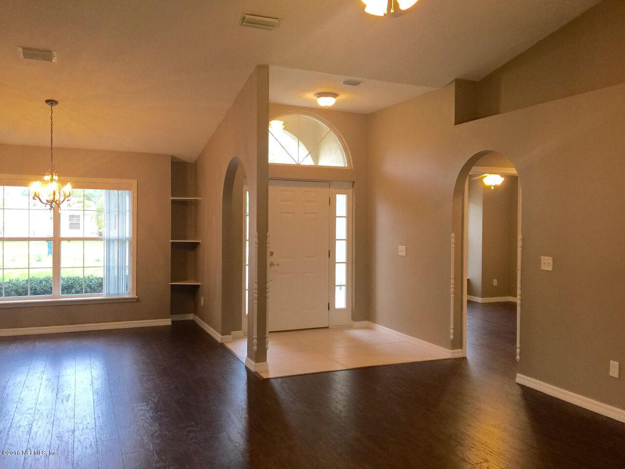 232 Orchis Road St. Augustine, FL 32086 - Photo 8 of 25 an empty room with wooden floor and windows