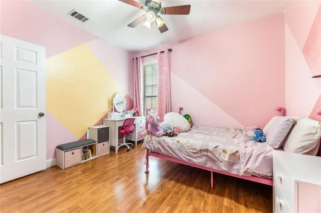 a bedroom with furniture and a wooden floor