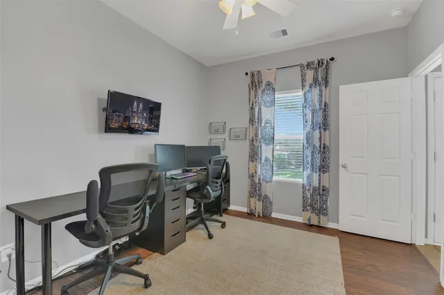 a view of a workspace with furniture and a window