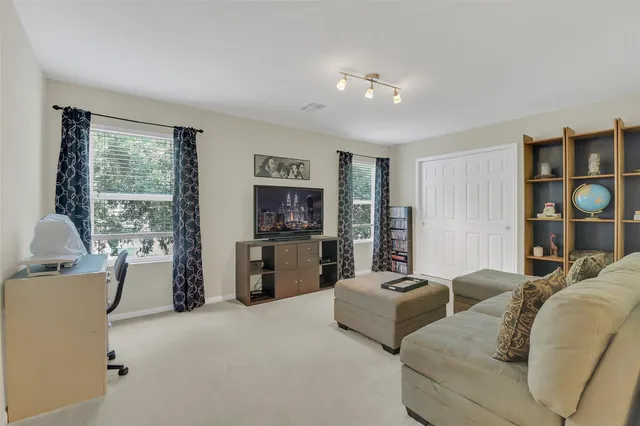 a living room with furniture ceiling fan and a window