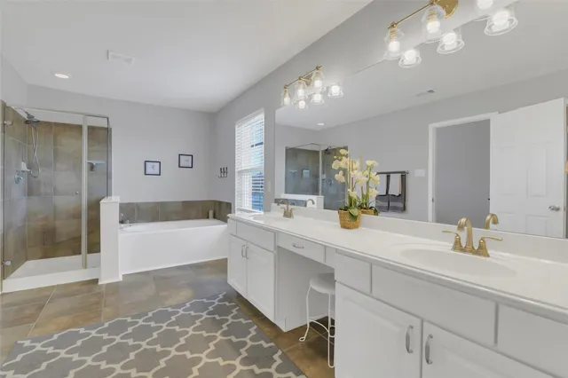 a bathroom with a tub sink and mirror