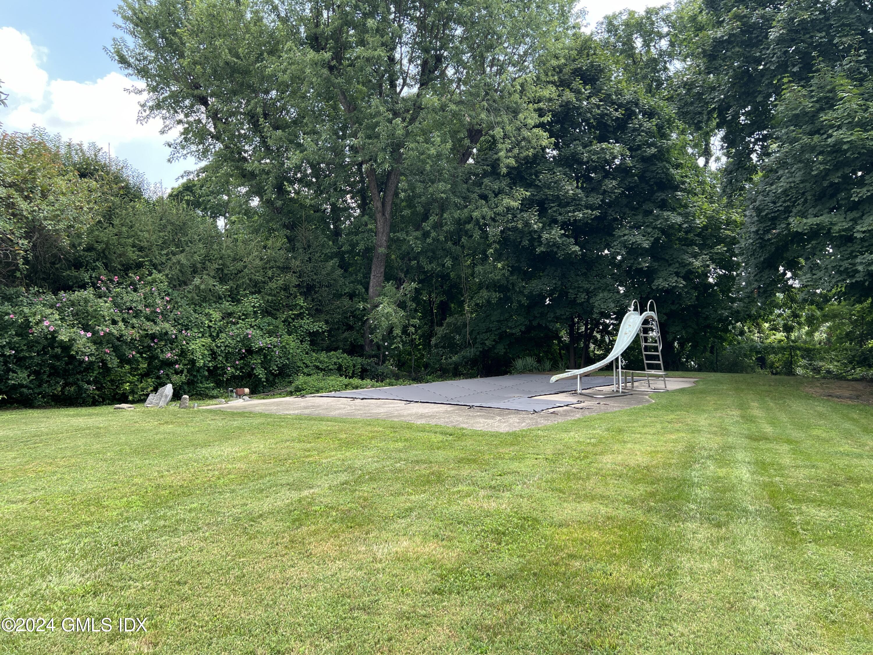 12 Norias Road Greenwich, CT 06830 - Photo 4 of 7 a view of a swimming pool and a yard
