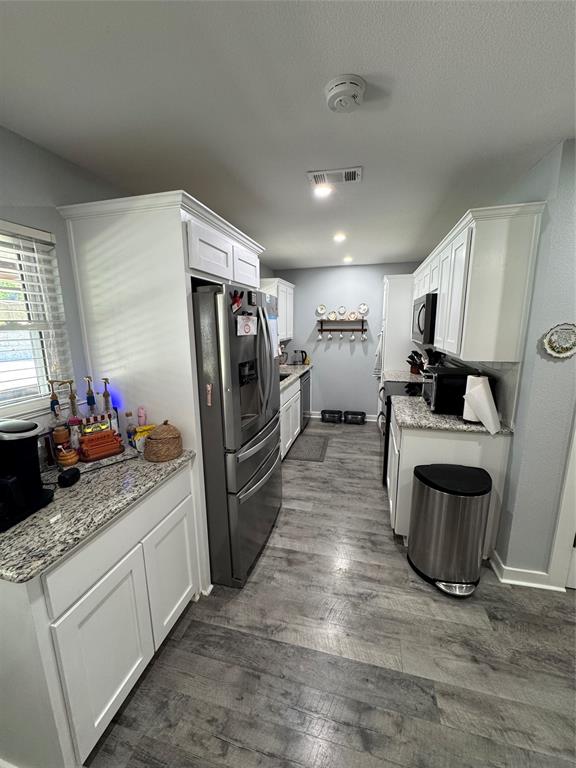 1525 Smith Road Howe, TX 75459 - Photo 5 of 24 a kitchen with refrigerator and cabinets