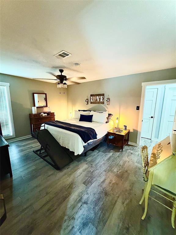 1525 Smith Road Howe, TX 75459 - Photo 9 of 24 a spacious bedroom with a bed and a chandelier
