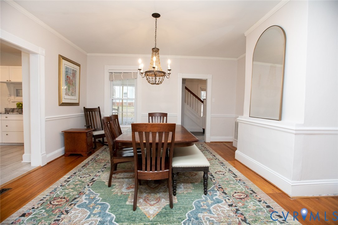 401 2nd Avenue Farmville, VA 23901 - Photo 21 of 55 a dining room with wooden floor a chandelier a wooden table and chairs